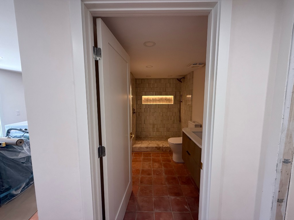 Looking through the doorway into the finished casita bathroom