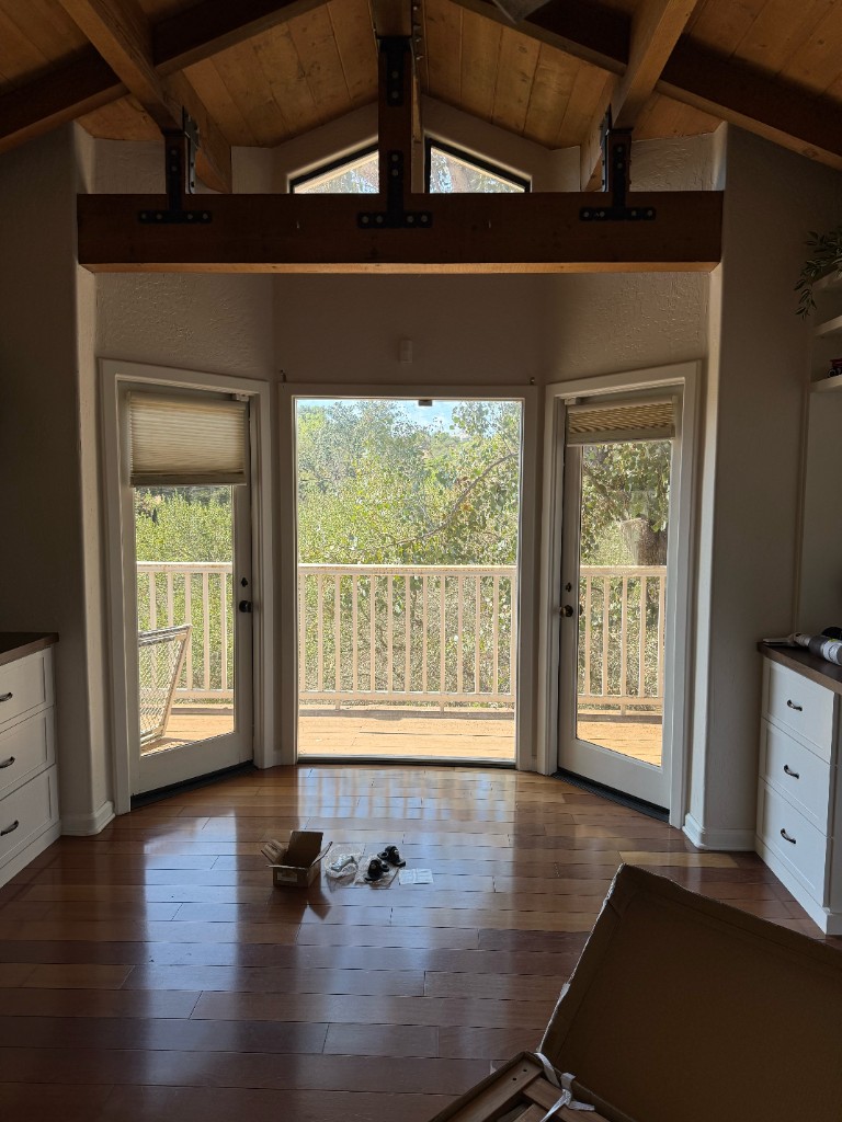 Timber beam and black steel brackets set in the vaulted sunroom