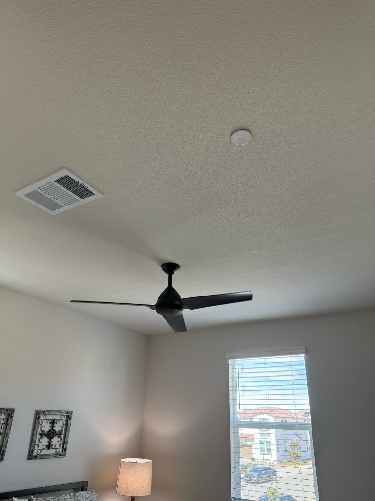 Three-blade ceiling fan hung in a Temecula bedroom